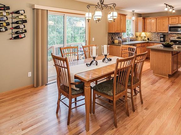 Spacious eating area with lots of natural light, views of the pond and access to the multi-level deck