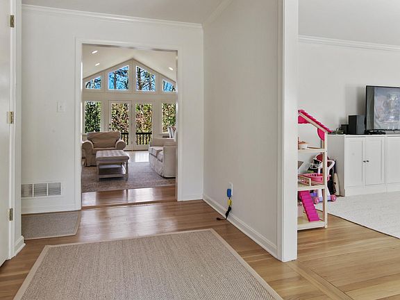 Standing in foyer w/family room straight ahead; living room on right; coat closet on left; and hallway to 3 main floor bedrooms on left