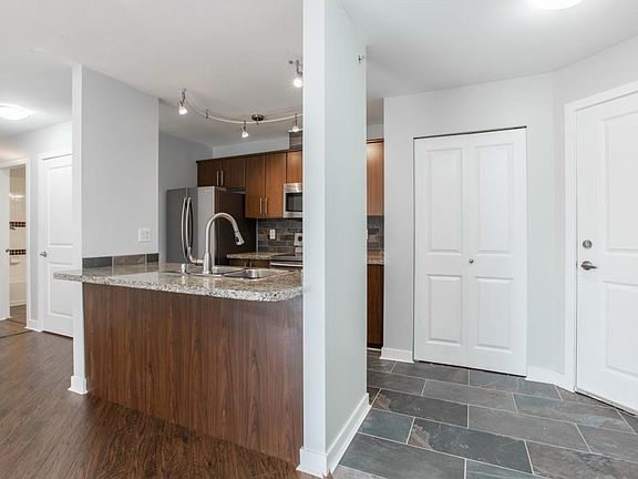 Open concept kitchen with stainless steel appliances and granite countertops