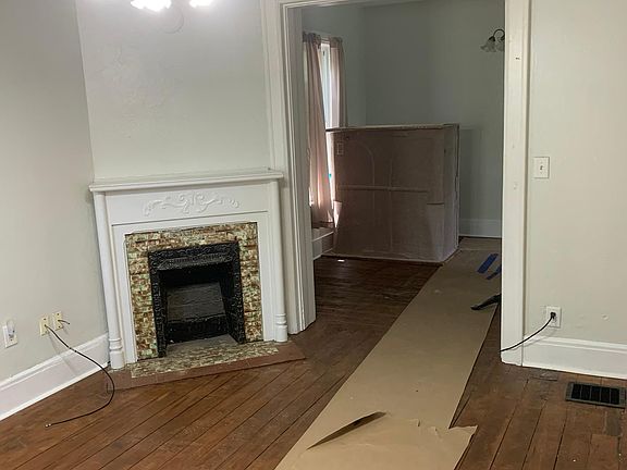 Living room with (non-functional) fireplace and refinished hardwood floors