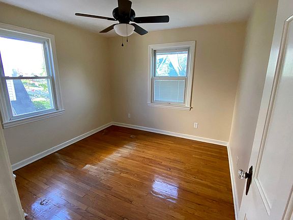 3rd bedroom with hardwood floors, cedar closet, ceiling fan, built-in bookcase & cedar closet
