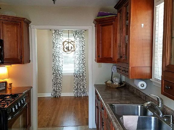 Kitchen going into dining room. Tiled floors in kitchen with all appliances included! Nice hardwood floors throughout house.