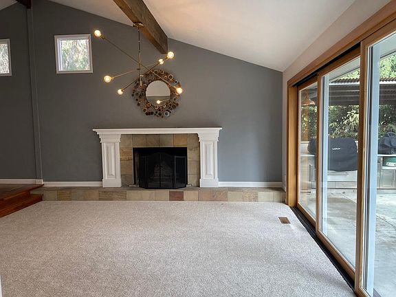 Main living area with a wood burning fireplace with a gas starter.