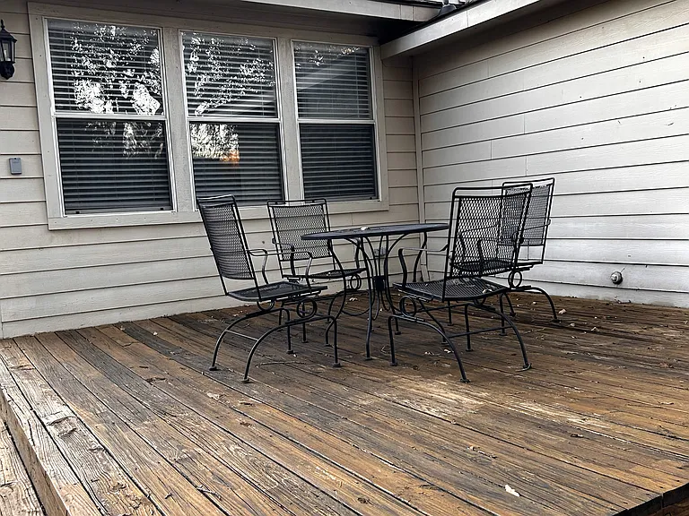 large deck in shaded back yard