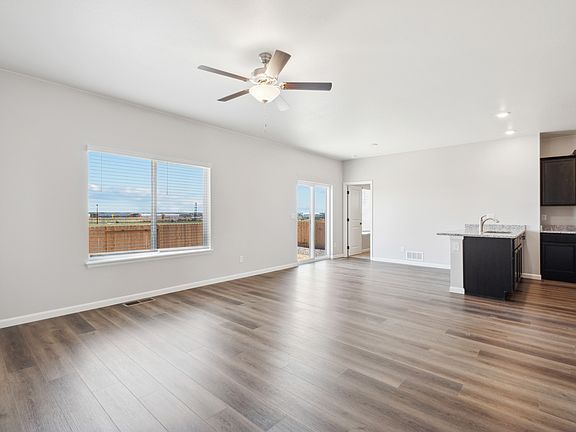 Open layout with a large family room, dining area, and upgraded kitchen.