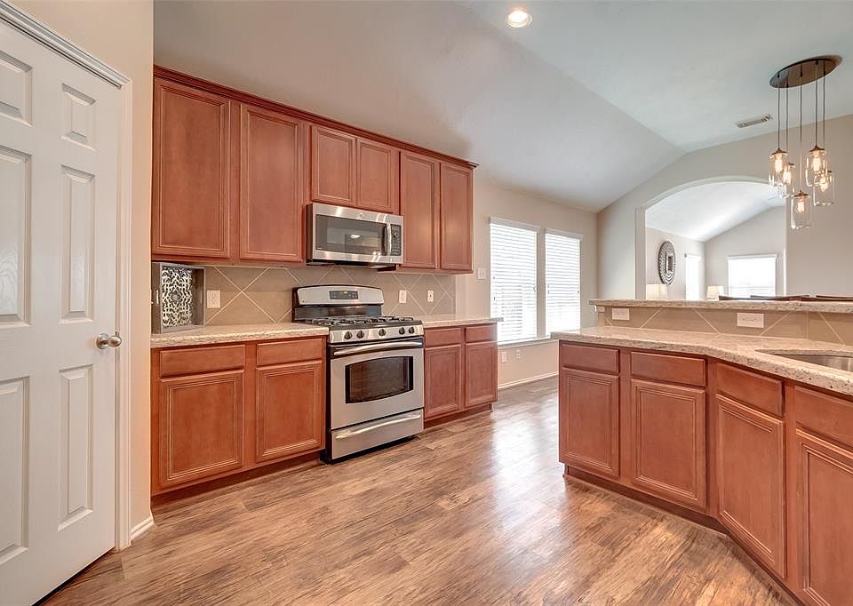 The gourmet kitchen is well appointed with GE Profile stainless steal appliances, including electric oven with gas range, dishwasher and convection microwave.