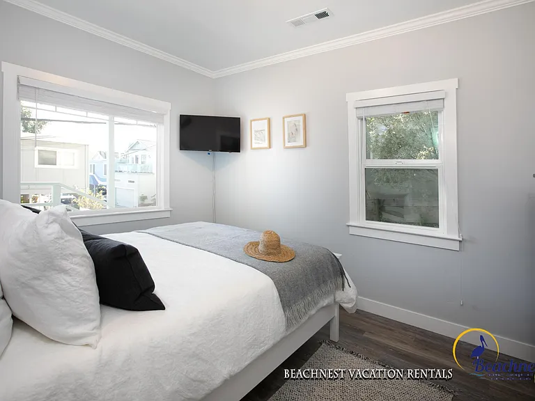 Master bedroom with wall mounted TV.