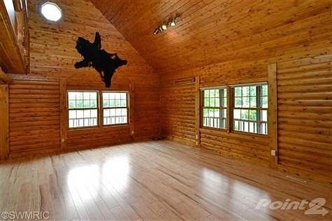 Living room with vaulted ceiling and plenty of windows.