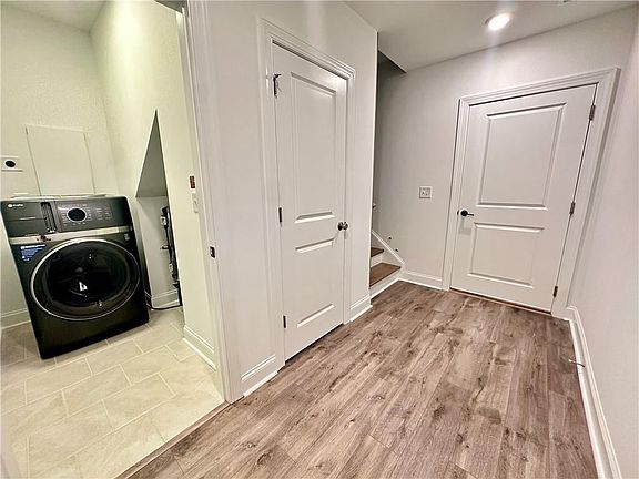 All homes come standard with GE Profile Washer Dryer Combo Photos shown are from same floor plan, b