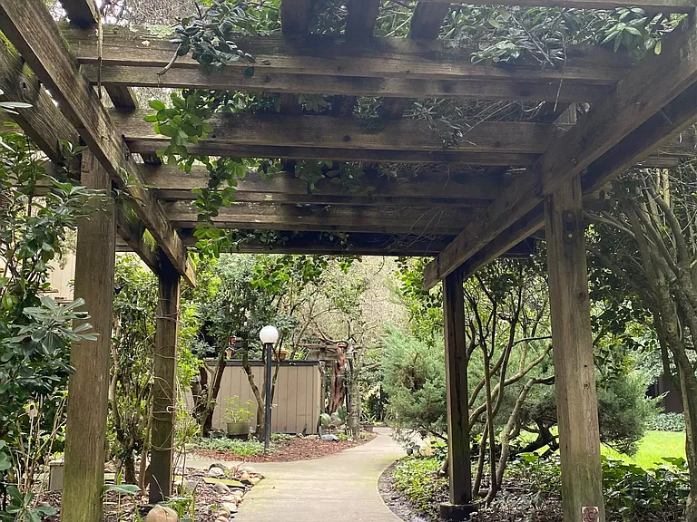 Peaceful arbor-covered walkway to your new home.