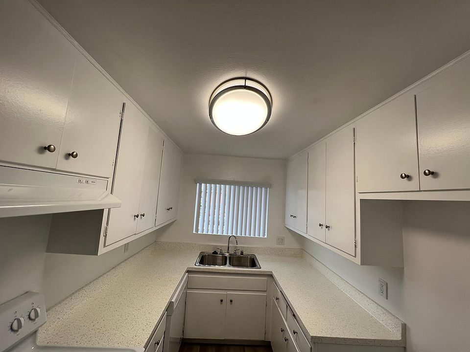 Looking toward kitchen 1x1 
Refrigerator opening on right side and electric stove on left side.