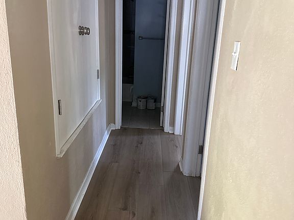 Hallway view from top of stairs- closet on left, bedrooms 2 and 3 on right