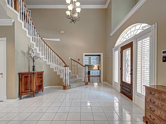 A graceful staircase introduces the two story entry.