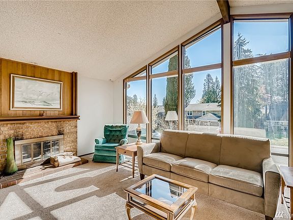 Light-filled great-room with cozy fireplace and vaulted ceiling.