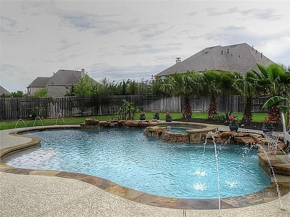 The backyard is an OASIS with SPARKLING pool, soothing spa, rock waterfall on an enormous 15,000 sq ft lot!
