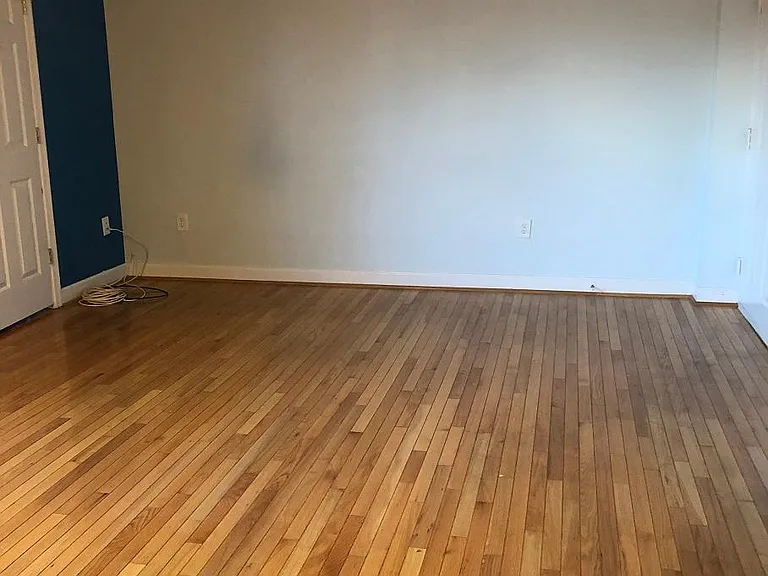 Living room. Looking south from bathroom door. Bedroom door on left.