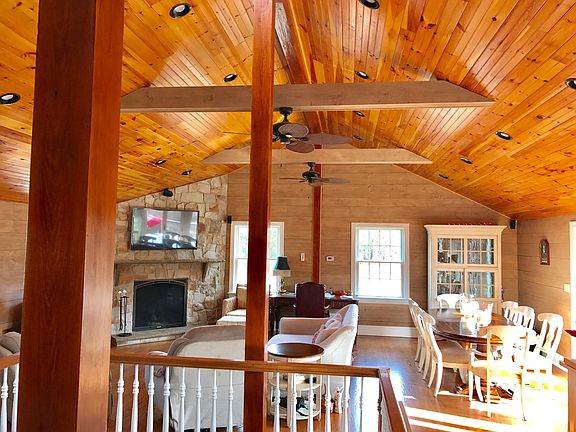 Living room with large fireplace, open floor plan, French doors to massive deck.