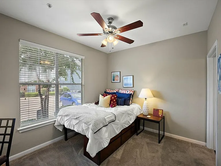 Bright Bedroom with Large Window and Ceiling Fan at Eagle Flatts Apartments, Hattiesburg, MS