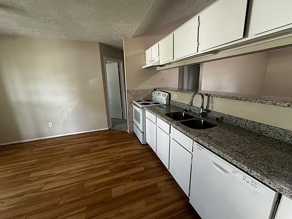 Kitchen, new paint on cabinets and new granite countertops. New Vent Hood over oven range.