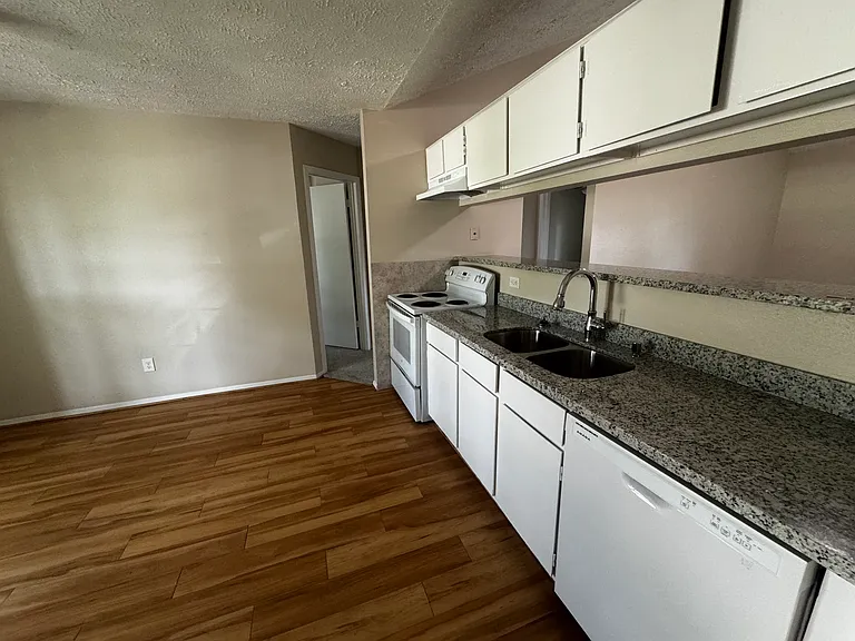Kitchen, new paint on cabinets and new granite countertops. New Vent Hood over oven range.