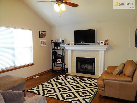 New engineered hard wood flooring, vaulted ceiling with fan, wood burning fire place, tiled fireplace front and enameled trim.