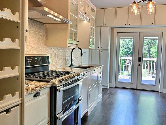 Wow. This is an amazing kitchen. All the cabinet drawers are lighted, double oven gas cooking, granite composite single deep sink.