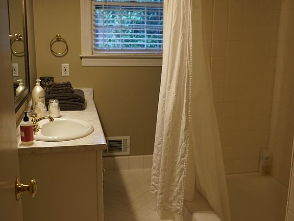 Hallway bathroom with large tub