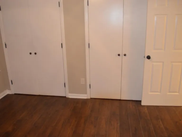 Main Floor Bedroom with Custom Walnut Flooring