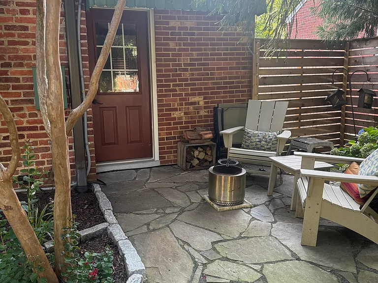 Private entrance with outdoor seating and Solo Stove fire pit.