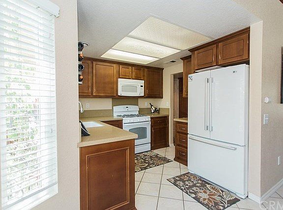Remodeled kitchen has gorgeous cabinets and upgraded countertops.