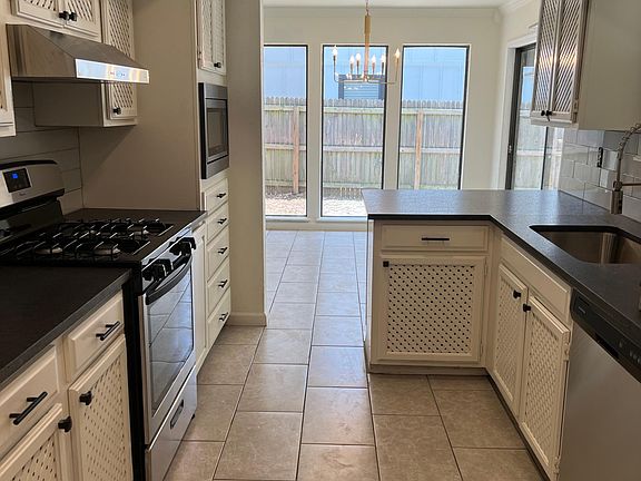 Leather looking granite counter tops new tile flooring and all new appliances