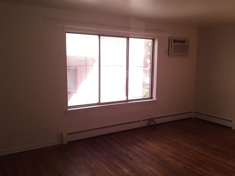 Living room. The apartment's through the wall air conditioner is located in the living room. The landlord provides heat through baseboard heaters that are present throughout the apartment.
