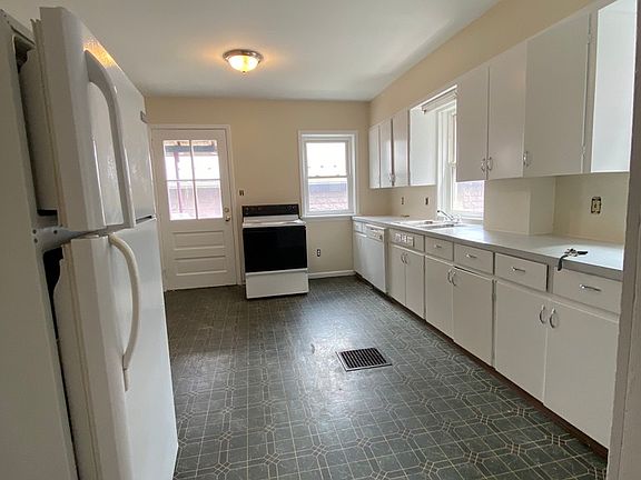 Kitchen with dishwasher, stove, refrigerator and microwave