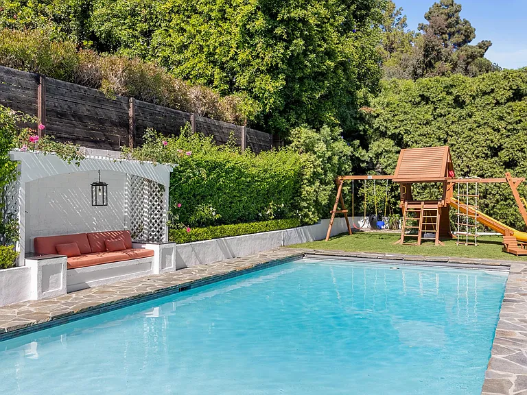 Experience a playful paradise with a jungle gym and pool, offering the perfect blend of outdoor fun and refreshing relaxation.