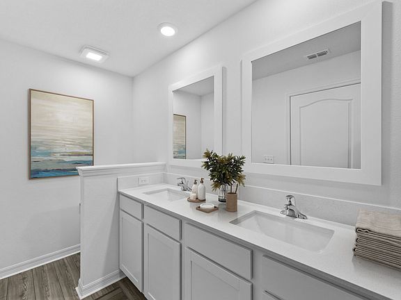 This master bathroom boasts a gorgeous dual-sink vanity