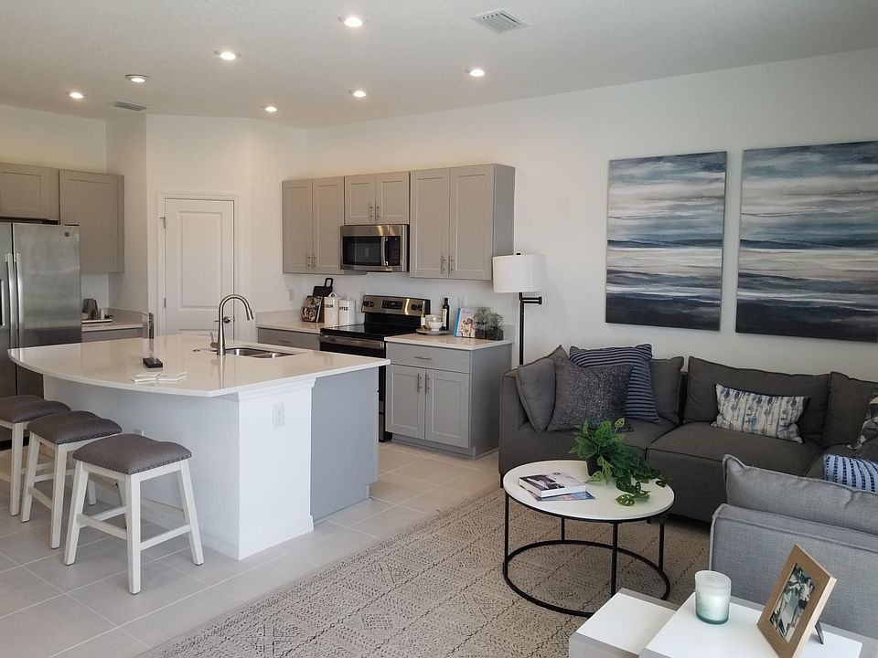Open-concept kitchen living area of the model home of the same townhouse plan, Jasmine
