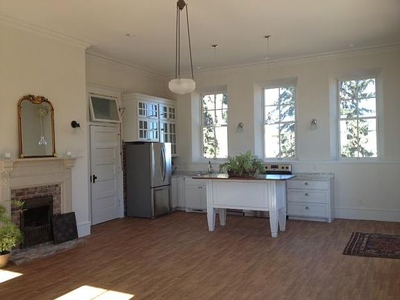 Custom kitchen open to living room with fireplace
