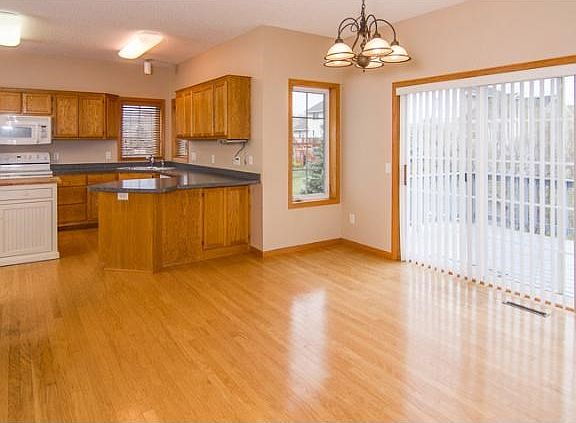 Opposite the Great room is the dining area. The hardwood floors from the entryway continue throughout the kitchen and into this room.