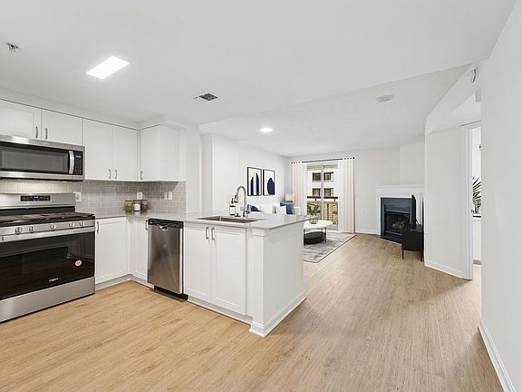 Renovated Package II kitchen and living room with hard surface flooring