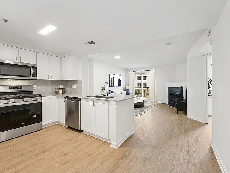Renovated Package II kitchen and living room with hard surface flooring