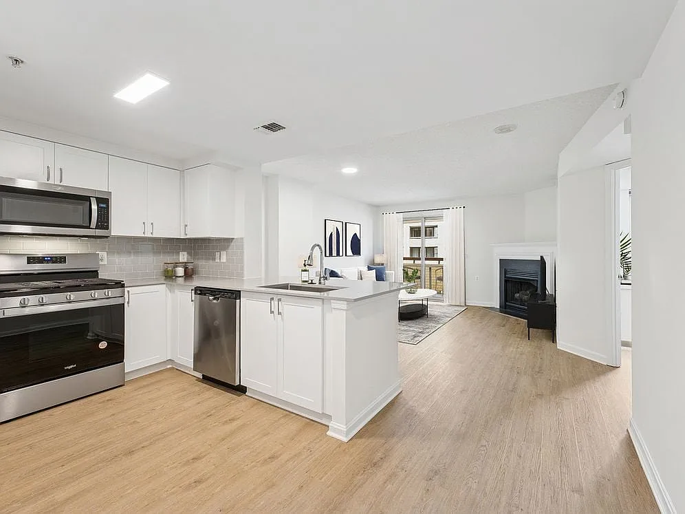 Renovated Package II kitchen and living room with hard surface flooring - Avalon Courthouse Place