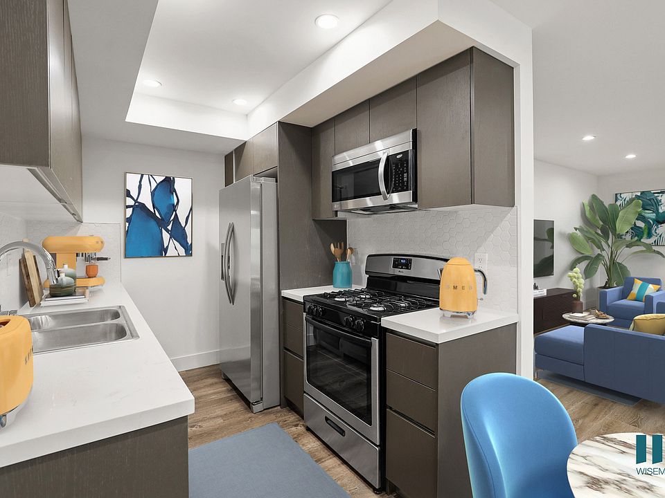 Kitchen with Stainless-Steel Refrigerator, Stove, Microwave Oven, and Patio