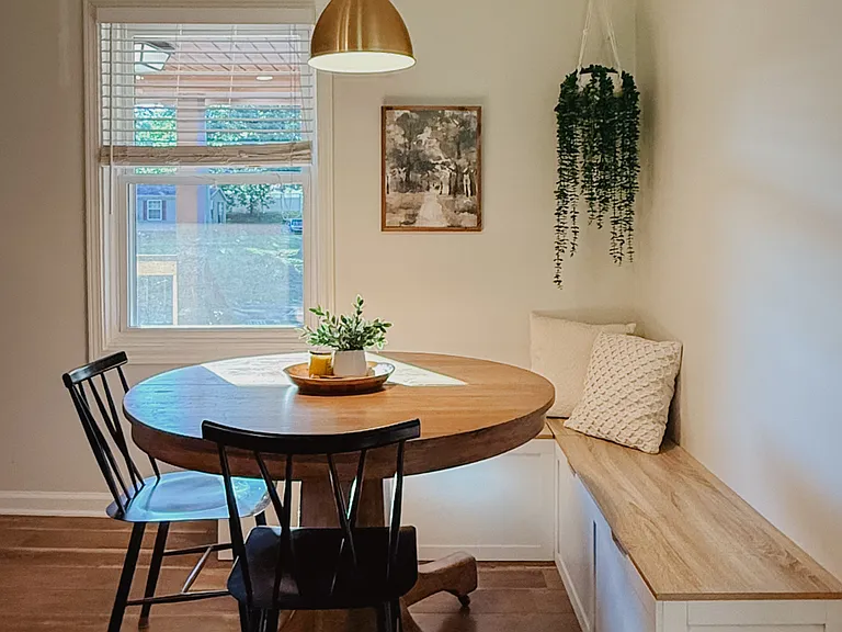 Breakfast nook with a built-in storage bench and a rustic oak table