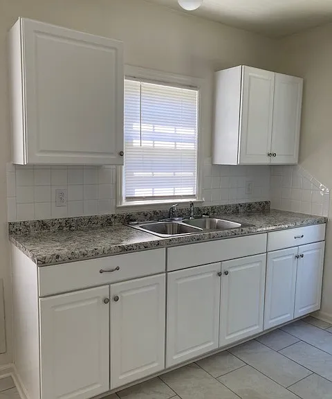 Kitchen with tile floor and laminate countertops