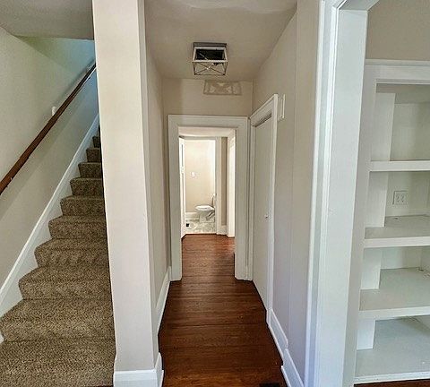 Another view of the entry. Stairs to the upstairs, hallway to the half bathroom- to the right is the living room