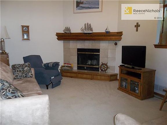 Great Room features ceiling fan and wood burning fireplace with