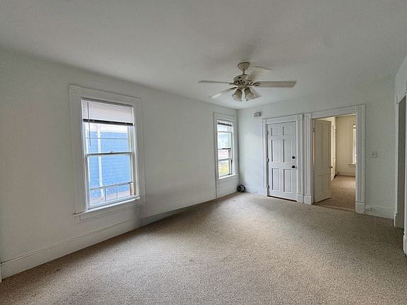 Living room with two ample storage closets.