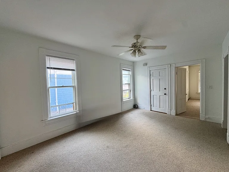 Living room with two ample storage closets.
