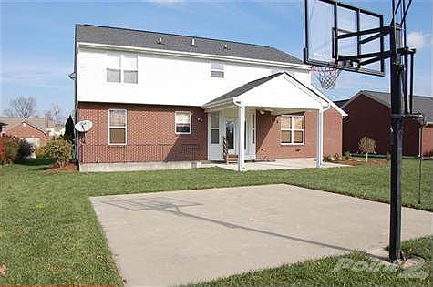 The backyard features a stairwell walk-out basement, this lovely covered back patio, and your own illuminated basketball court. Please note the cantalivered 2nd floor.  This upgrade adds considerable space to those rooms.