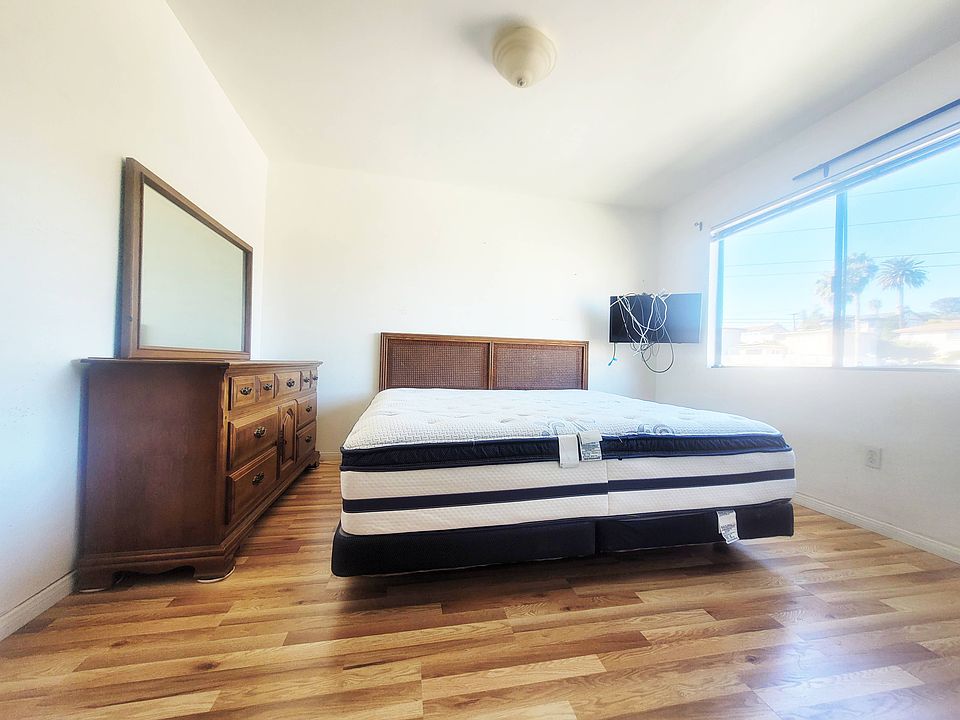 Sun filled queen size bed. Includes dresser, TV, and newly installed hardwood floors. (Curtains have been installed but not in photo)
